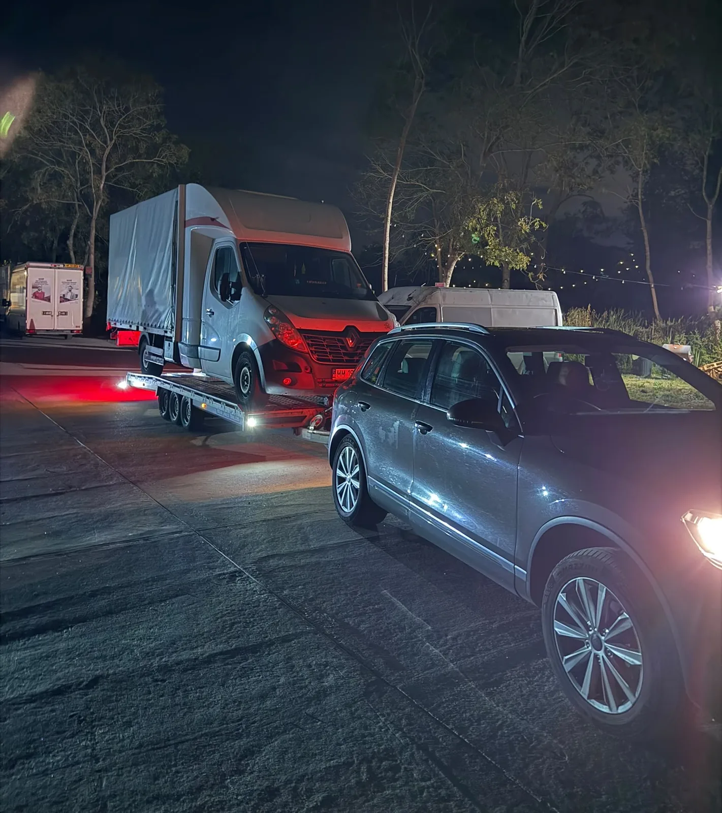 KCS Recovery transporter working at night with a box van loaded on the trailer