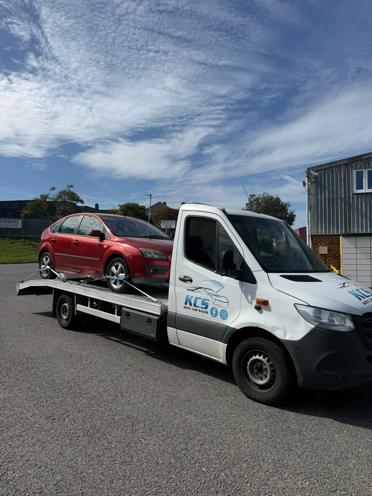 KCS Recovery transporter loaded with a red Ford Focus on a Kent road