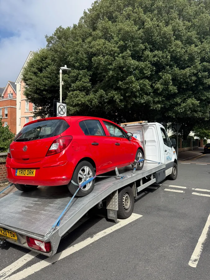 Red Vauxhall Corsa strapped and secured on the KCS Recovery truck bed