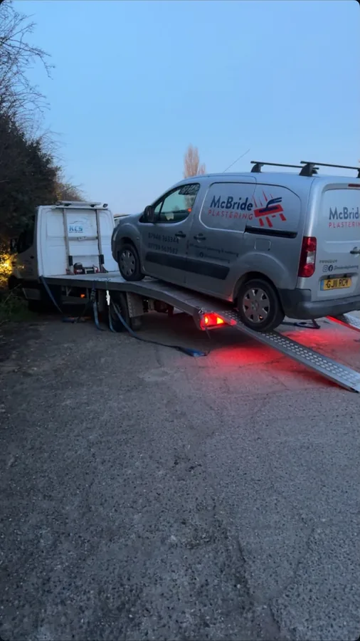 KCS Recovery truck loading a commercial plastering firm van onto the ramps